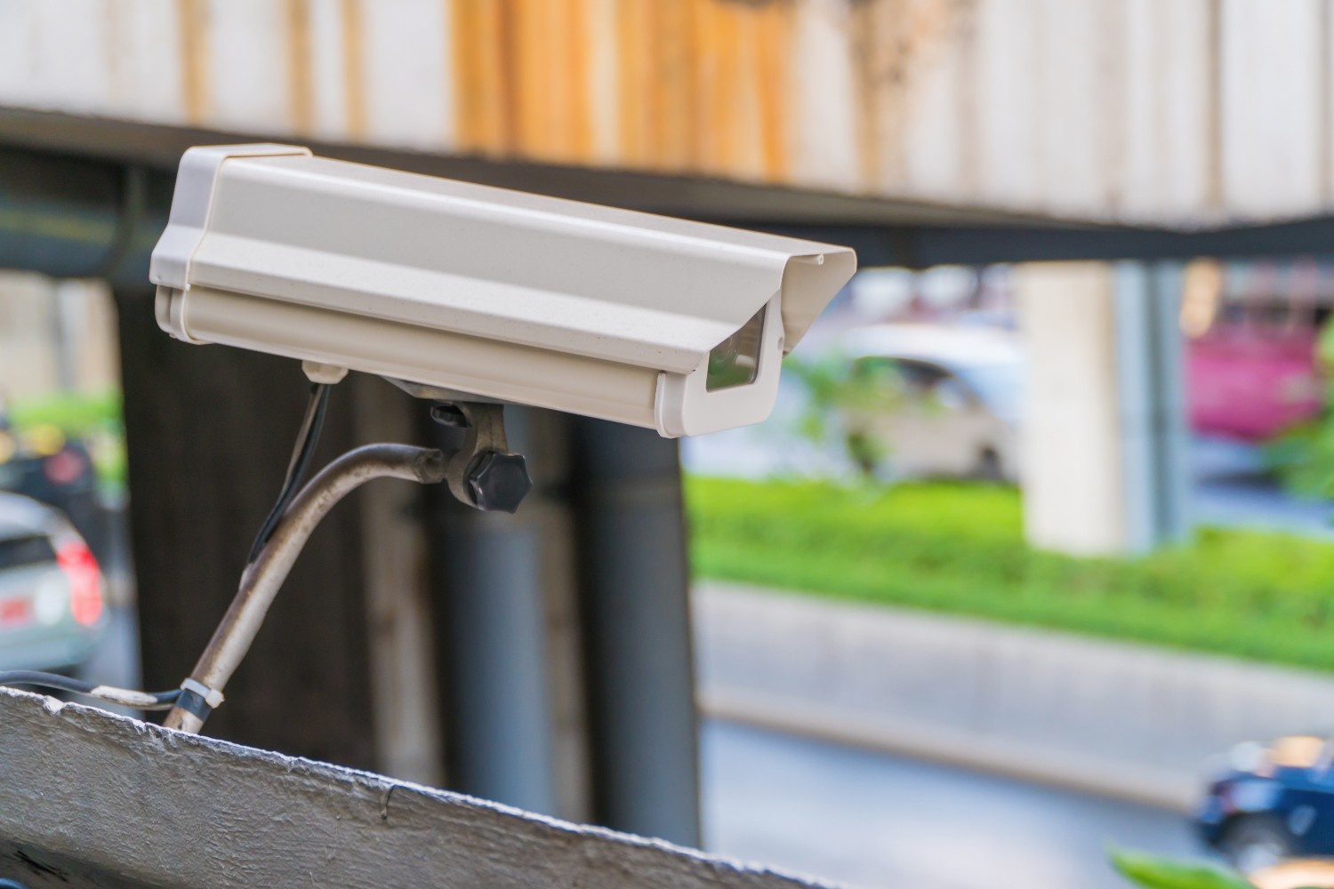 Outdoor surveillance camera mounted on a commercial building for security and networked monitoring systems.